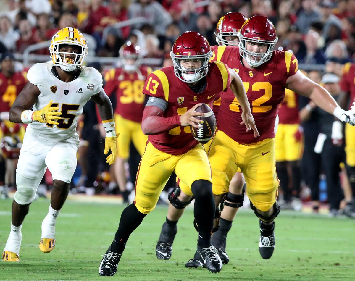 USC quarterback Caleb Williams scrambles with the ball through the Arizona State defense.