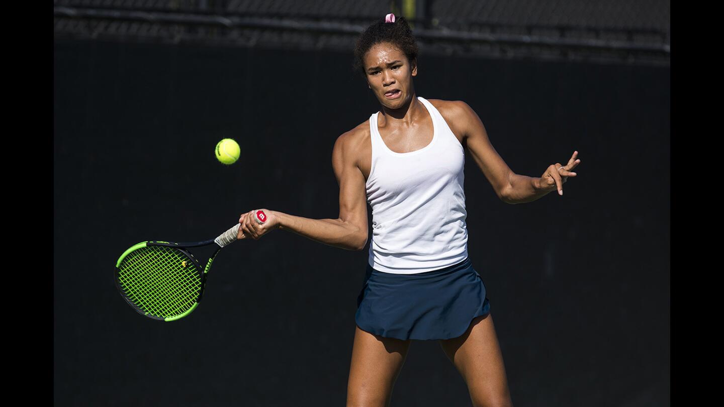 Corona del Mar's Annika Bassey retuns a forehand against a University player during a Pacific Coast League match at the Racquet Club of Irvine on Wednesday, October 18.