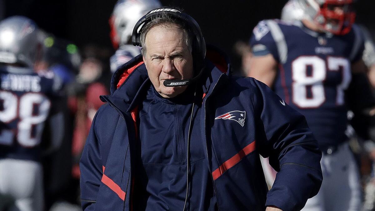 Patriots head coach Bill Belichick walks along the sideline before New England's AFC divisional round playoff game against the Chargers.