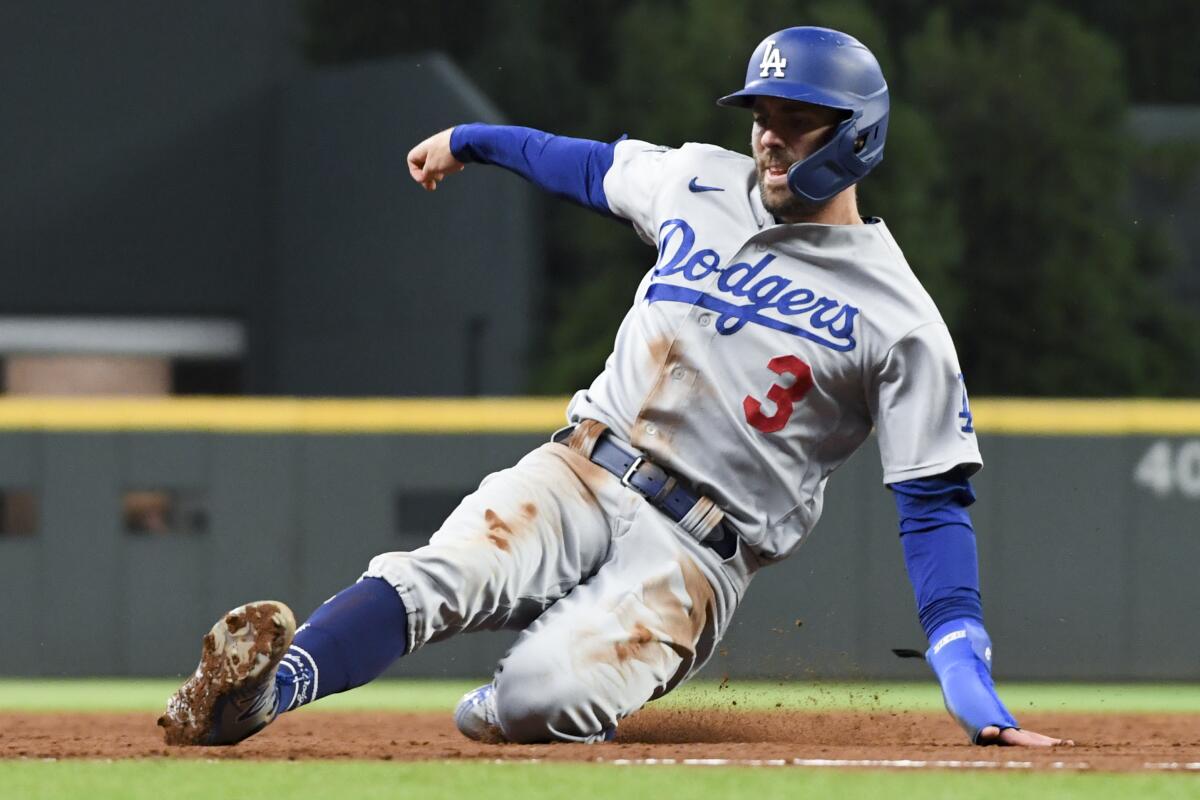 Chris Taylor slides into third on a pop fly by Cody Bellinger during the sixth inning for the Dodgers.