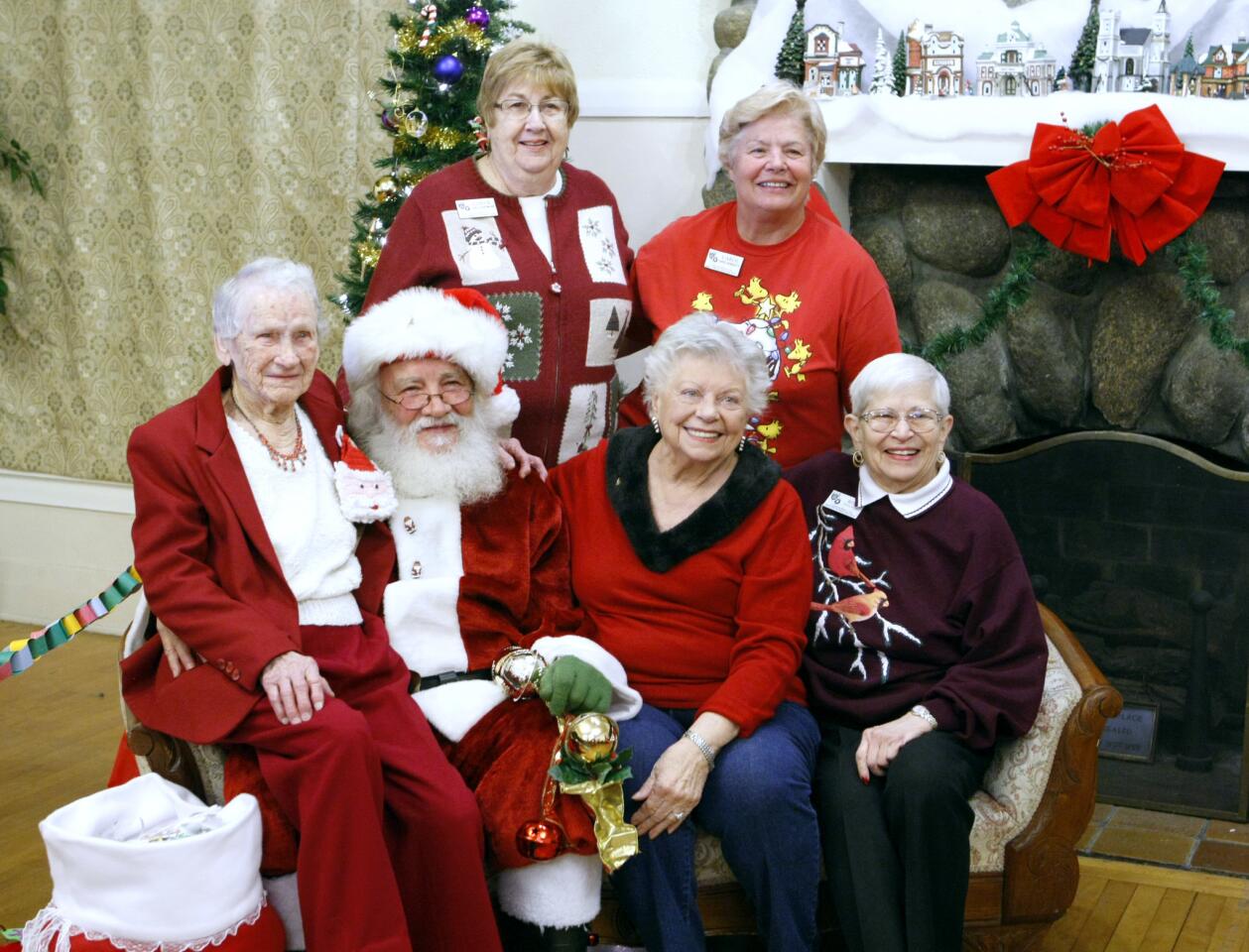 Taking a photo with Santa Claus are, top row from left, La Crescenta Woman's Club past president Carol Huntwork and Carol Benedetti, and front row from left are Jean Bates, 96, Dea McCrory and Rita Even, at the annual La Crescenta Woman's Club Breakfast with Santa, at the organization's clubhouse in La Crescenta on Saturday, Dec. 10, 2016.