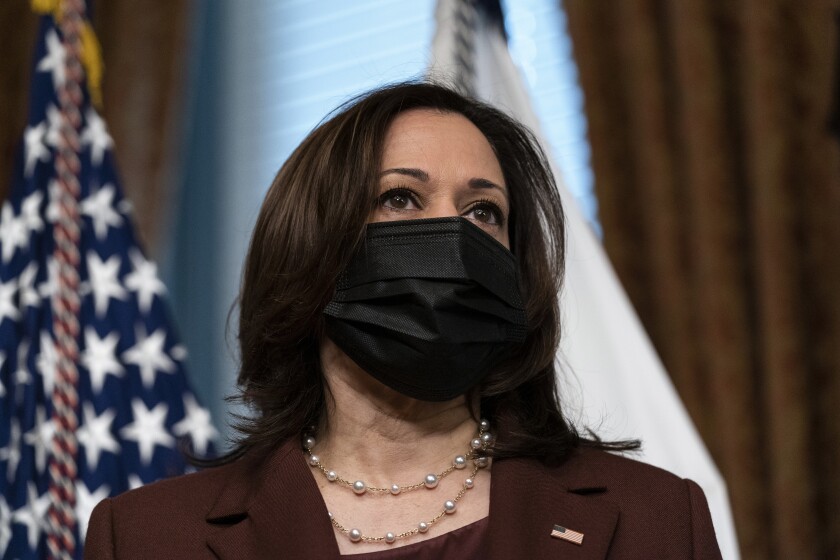 Vice President Kamala Harris wearing a black mask.