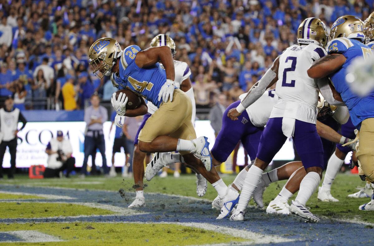 UCLA running back Zach Charbonnet scores a touchdown against Washington in the first quarter.