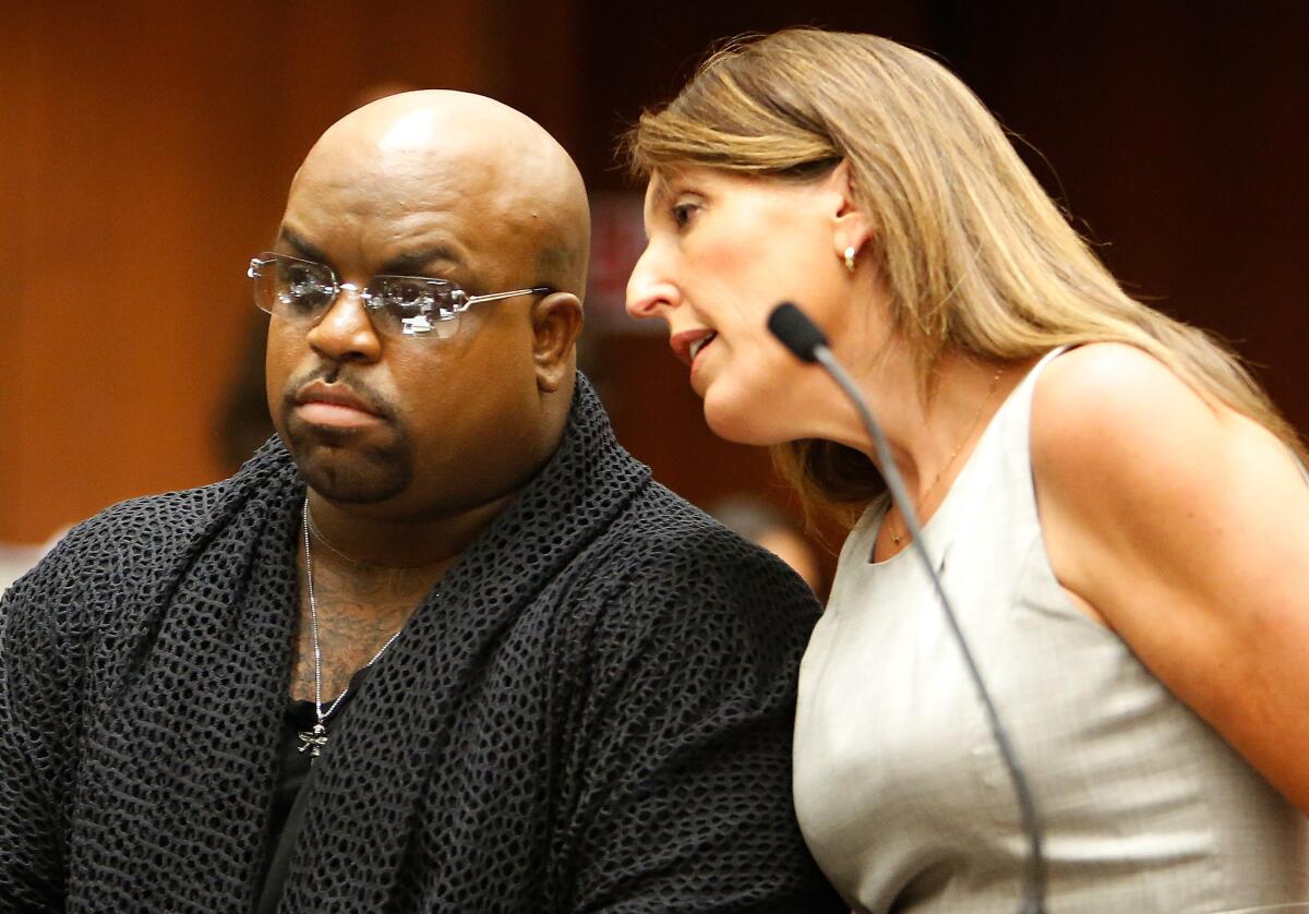 Singer Cee Lo Green, left, with attorney Blair Berk, pleads not guilty to providing the party drug ecstasy to a woman last year while dining at a downtown Los Angeles restaurant.