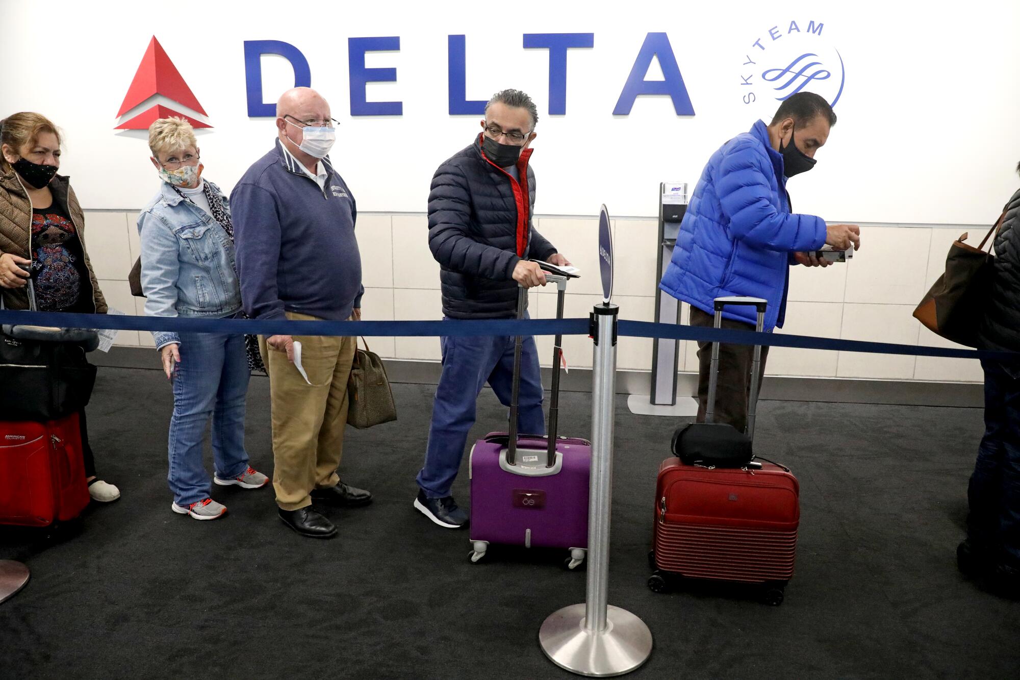 Jorge Mejia Avante, center, and his brother Alfredo Mejia Avante, right, board a plane.