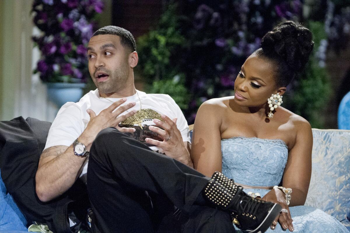 Apollo Nida, shown with wife Phaedra Parks during the taping of a "Real Housewives of Atlanta" reunion special in March, was sentenced Tuesday to eight years in federal prison.