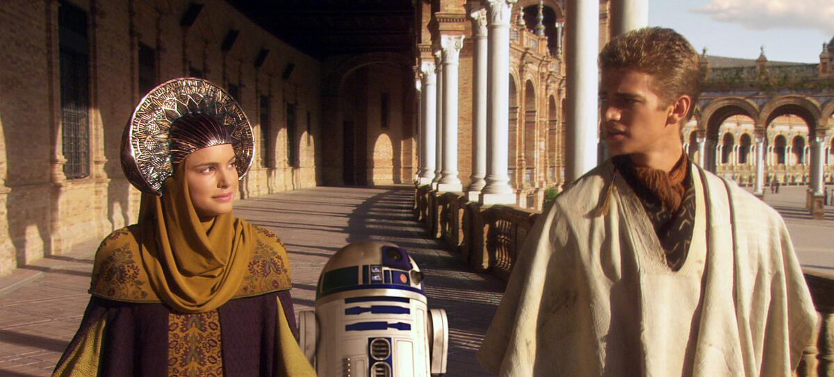Padme Amidala and Anakin Skywalker walk down an archway