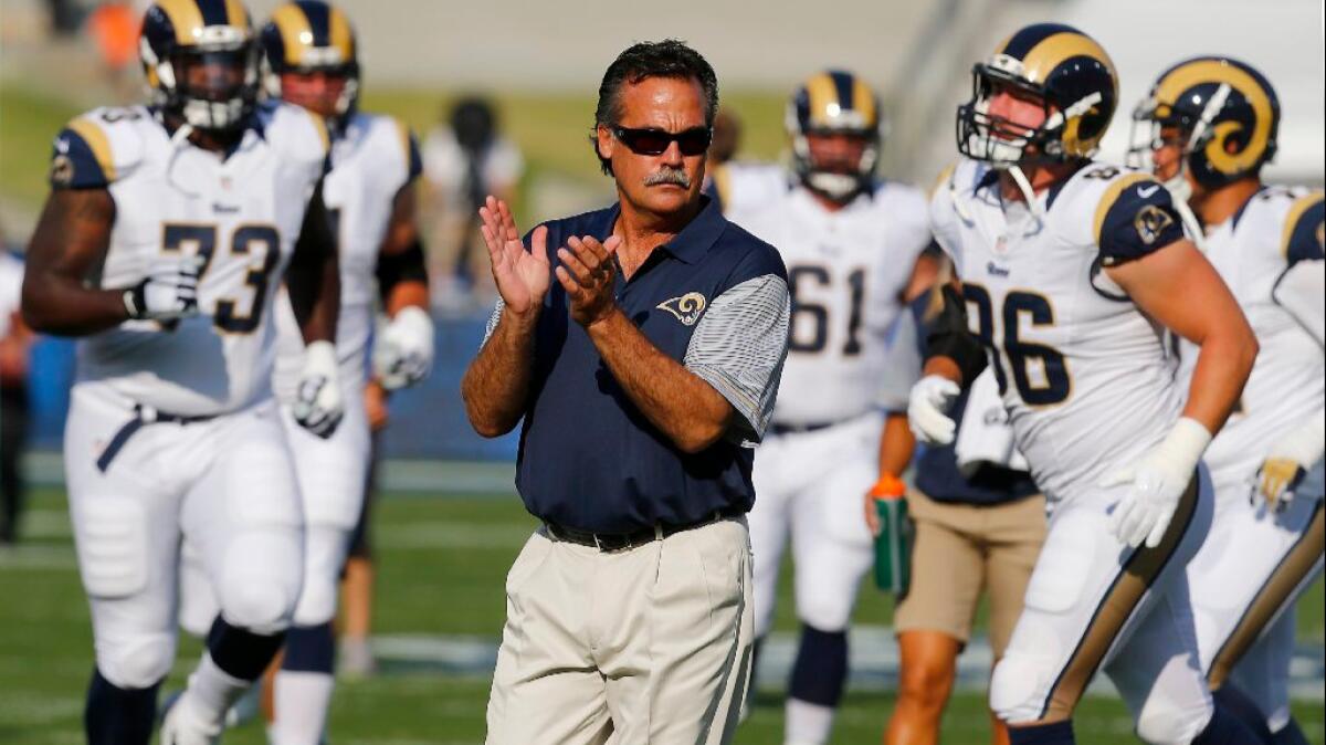 Rams Coach Jeff Fisher watches his team warm up before a preseason game against the Kansas City Chiefs at the Coliseum on Aug. 20.