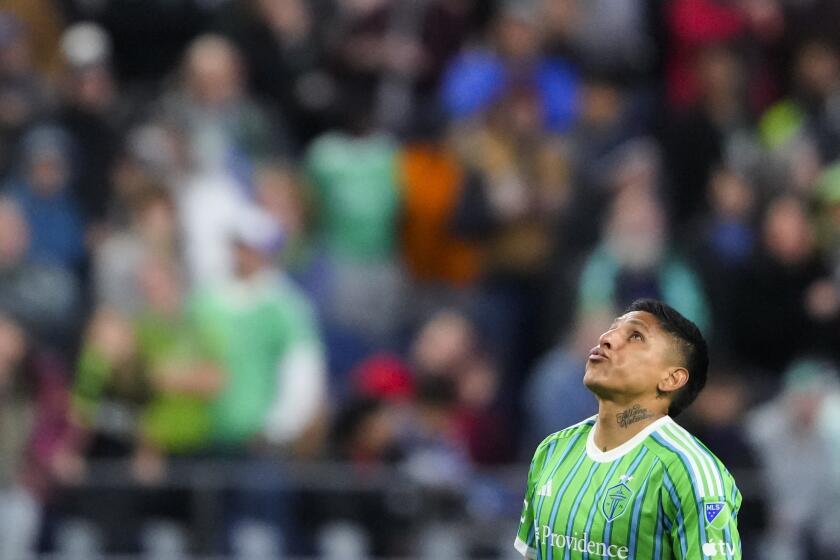 Seattle Sounders forward Raúl Ruidíaz reacts while waiting for an official to review a play during the first half of the team's MLS soccer match against the Vancouver Whitecaps, Saturday, April 20, 2024, in Seattle. The review resulted in a red card for Sounders defender Jackson Ragen. (AP Photo/Lindsey Wasson)