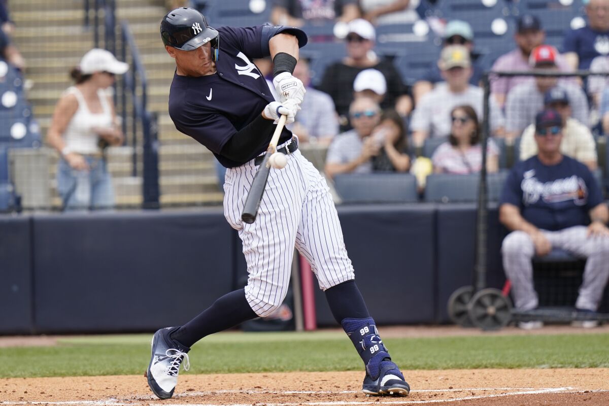 New York Yankees' Aaron Judge hits a solo home run during the first inning of a spring training baseball game against the Atlanta Braves, Saturday, April 2, 2022, in Tampa, Fla. (AP Photo/Lynne Sladky)