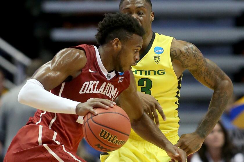 Oklahoma guard Buddy Hield drives to the basket againt Oregon forward Elgin Cook during the second half of the West Regional Final on March 26 at Honda Center.