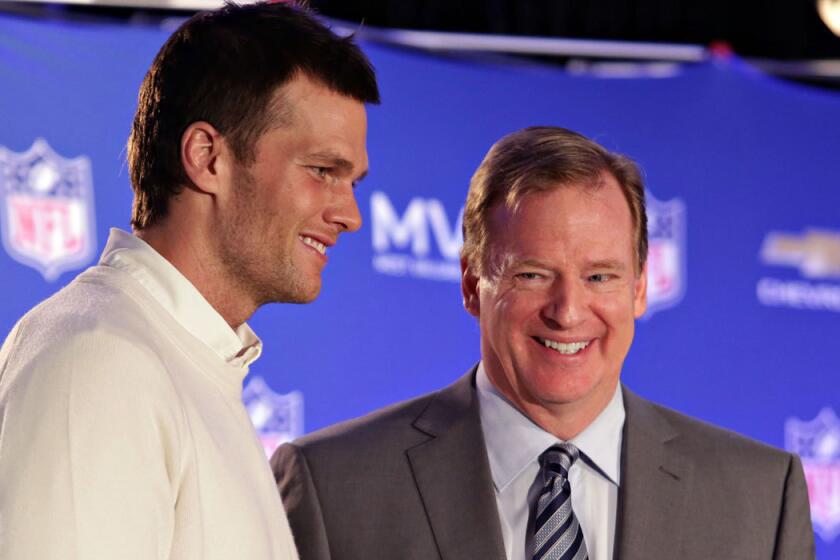NFL Commissioner Roger Goodell, right, presents New England quarterback Tom Brady with the Super Bowl MVP trophy in February.