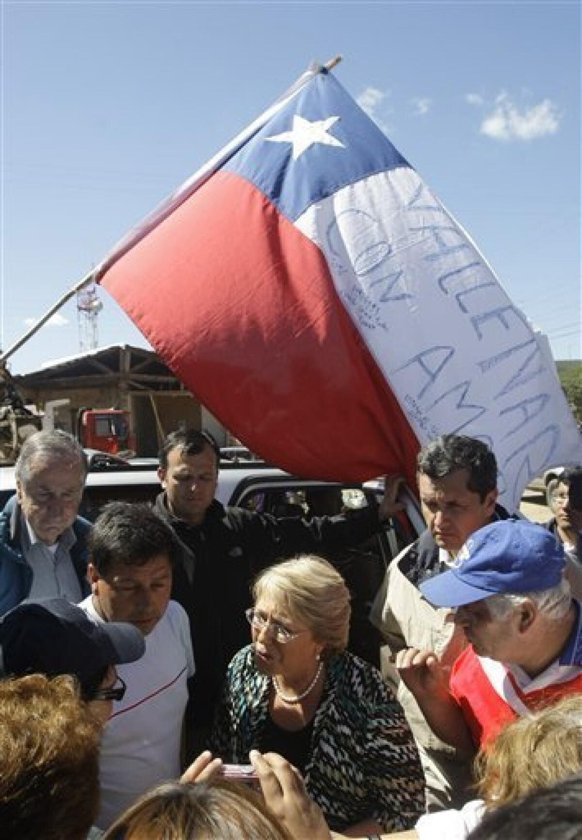 Chile's President Michelle Bachelet talks with earthquake survivors in Dichato, Chile, Monday, March 8, 2010. A devastating earthquake hit central Chile last Feb. 27, causing widespread damage. (AP Photo/Silvia Izquierdo)