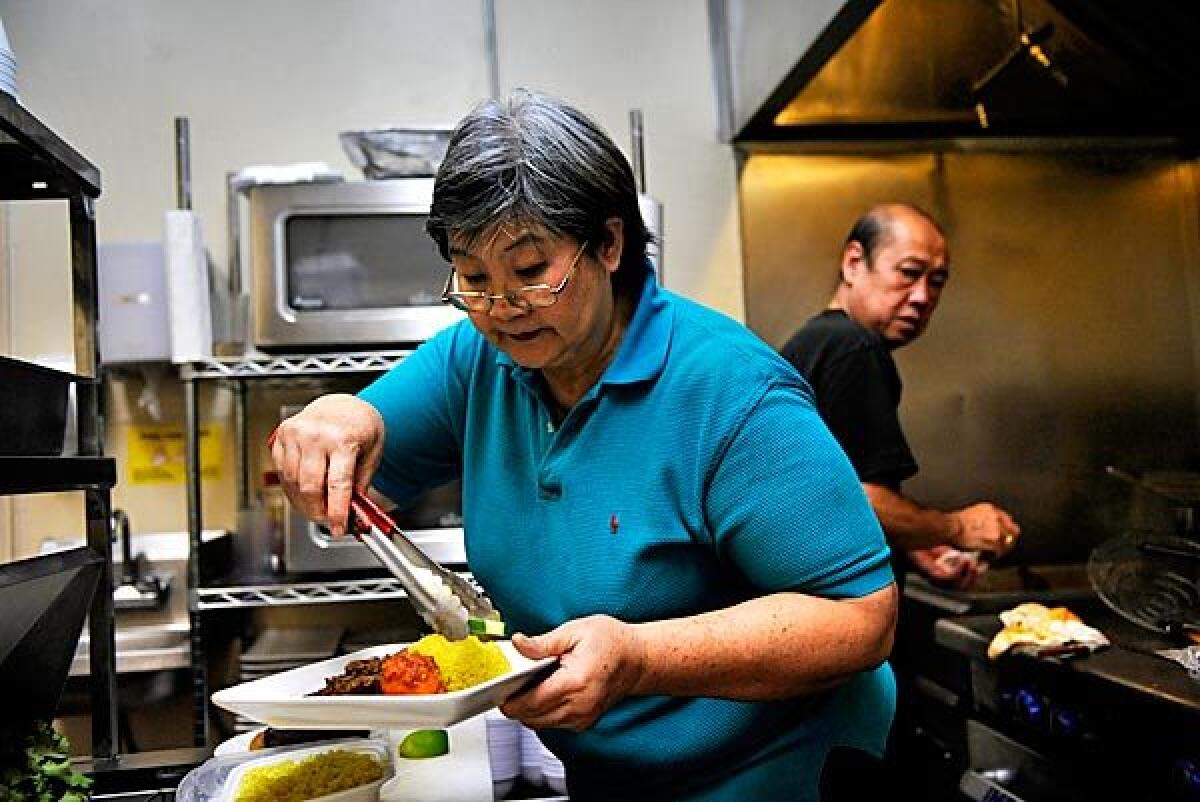 Merry Tio, left, recently opened her restaurant, Merry's House of Chicken, which specializes in Indonesian food.