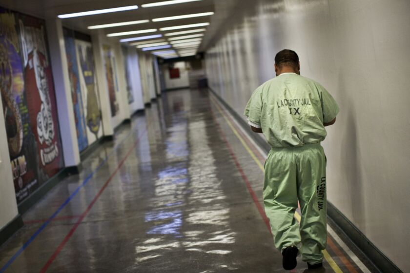 An inmate walks a hallway in Men's Central.