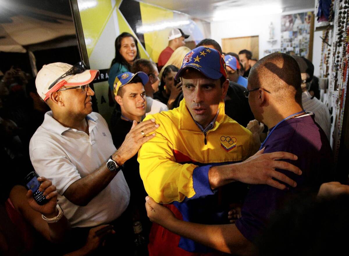 Henrique Capriles, center, receives congratulations in Caracas as initial results show him winning reelection as governor of Venezuela’s Miranda state.
