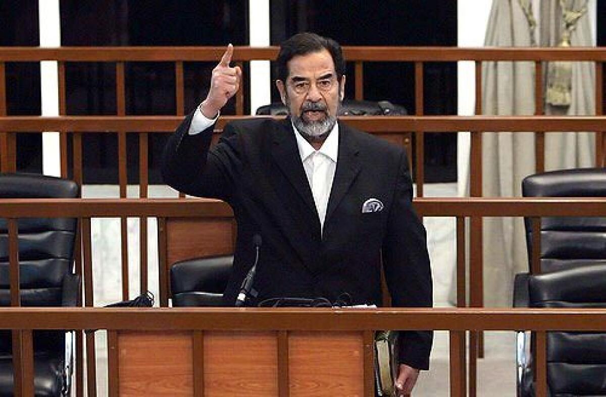 Former Iraqi President Saddam Hussein yells at the court as he receives his verdict.