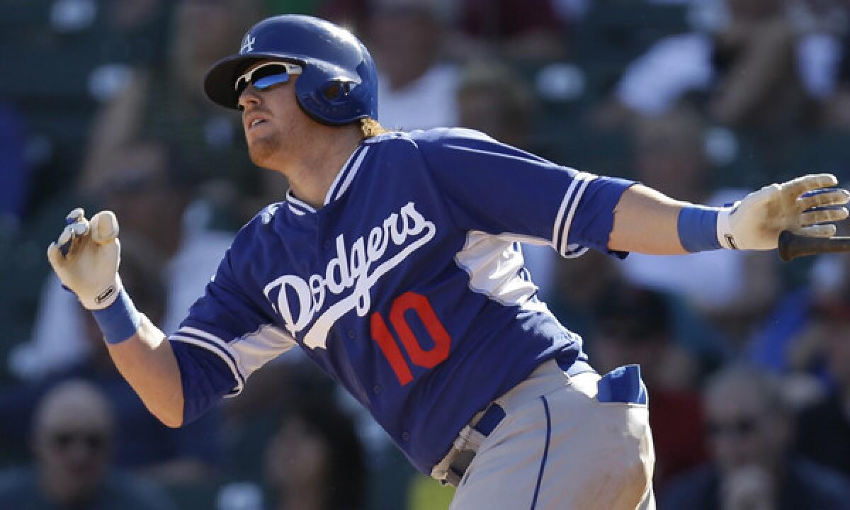 Dodgers shortstop Justin Turner hits a double against the Arizona Diamondbacks on Feb. 26. Turner had two hits in Saturday's Cactus League game against the Texas Rangers.