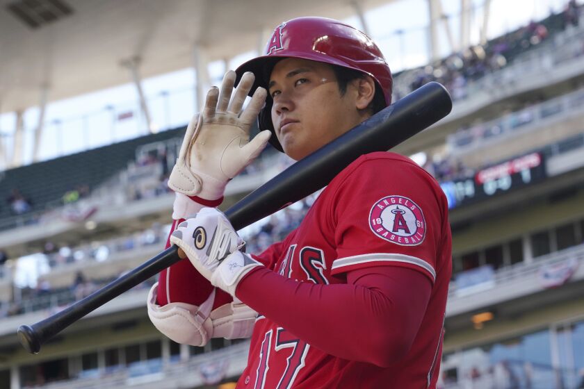 Los Angeles Angels' pitcher Shohei Ohtani (17) waves to fans as he waits on deck to bat in the fourth inning.