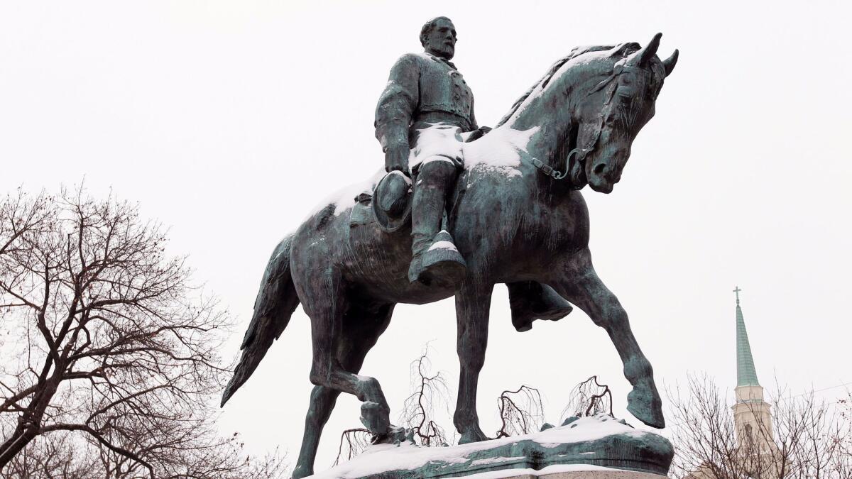 A statue of Robert E. Lee collects snow in Lee Park in Charlottesville, Va., on March 3, 2014. (Ryan M. Kelly / Associated Press)