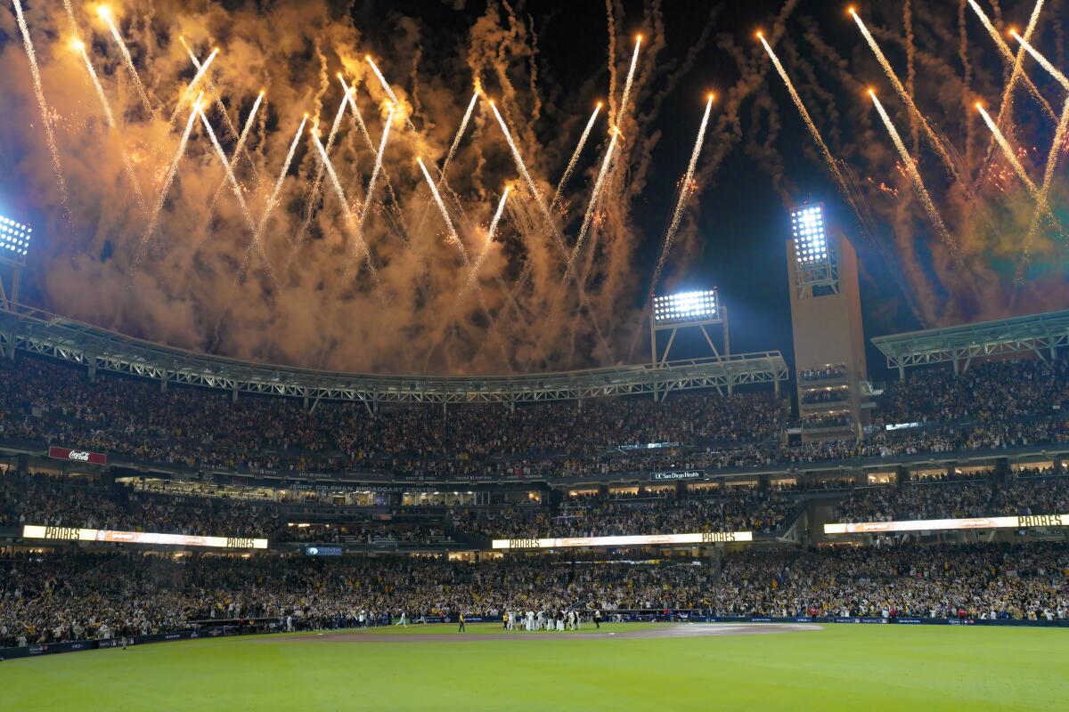 With fireworks exploding above Petco Park, the Padres celebrate after winning the NLDS against the Dodgers in October. 