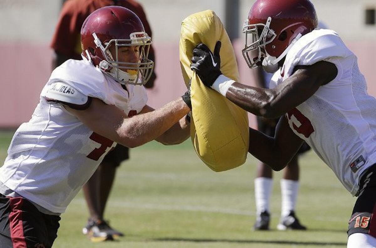 USC receivers Robby Kolanz, left, and Nelson Agholor participate in a training drill during a practice earlier this month.