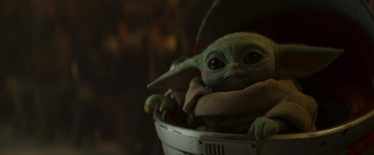 Baby Yoda looks forward in a scene from "The Mandalorian."
