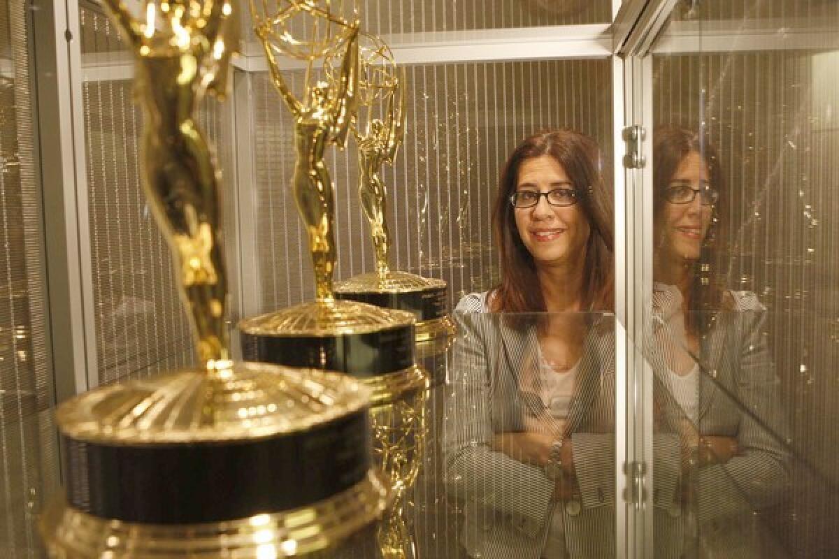 Hilary Estey McLoughlin, who oversees 1,200 employees and nine shows currently on the air as president of Warner Bros.' Telepictures Productions, stands behind her work in her Burbank office.