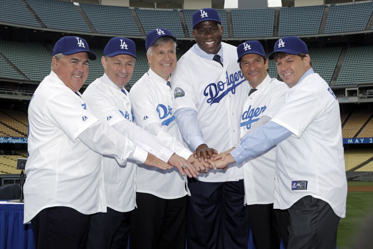The ownership group of the Dodgers pose in photo at Dodger Stadium in May 2012.