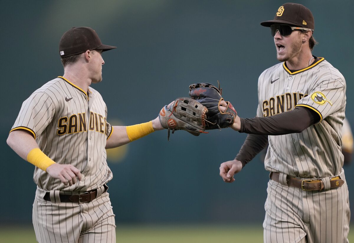 The Padres' Jake Cronenworth celebrates with Wil Myers after Myers 
