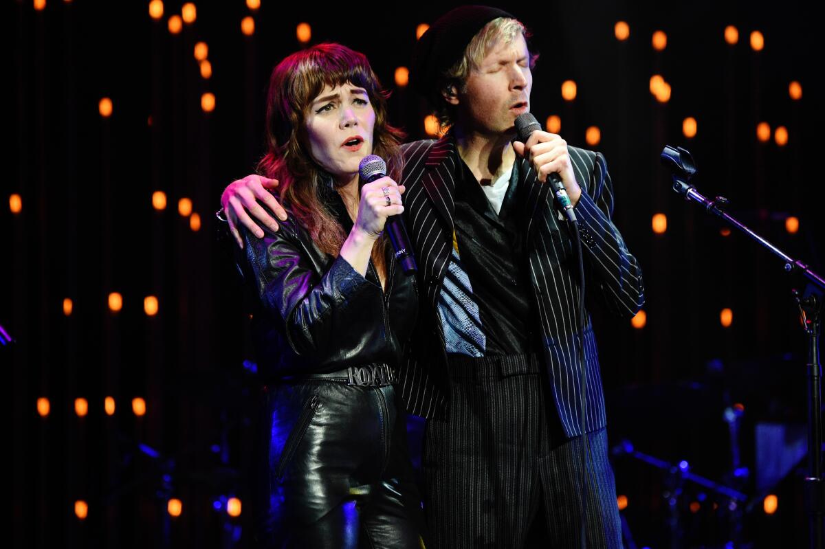 Jenny Lewis, left, and Beck perform onstage during the CORE Gala.