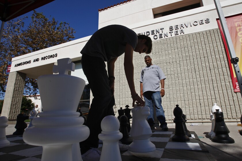 Saddleback Community College students play a game of chess on campus.