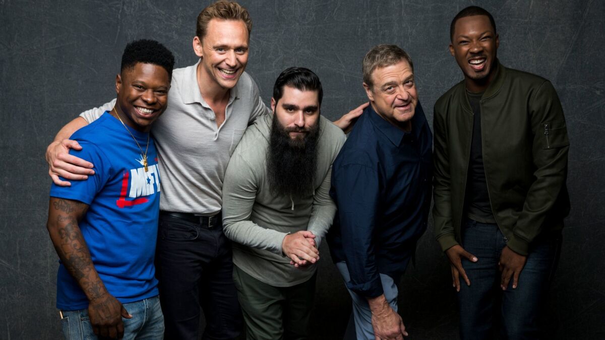The bearded Jordan Vogt-Roberts, center, with "Kong: Skull Island" cast members, from left, Jason Mitchell and Tom Hiddleston; from right, Corey Hawkins and John Goodman at Comic-Con 2016,