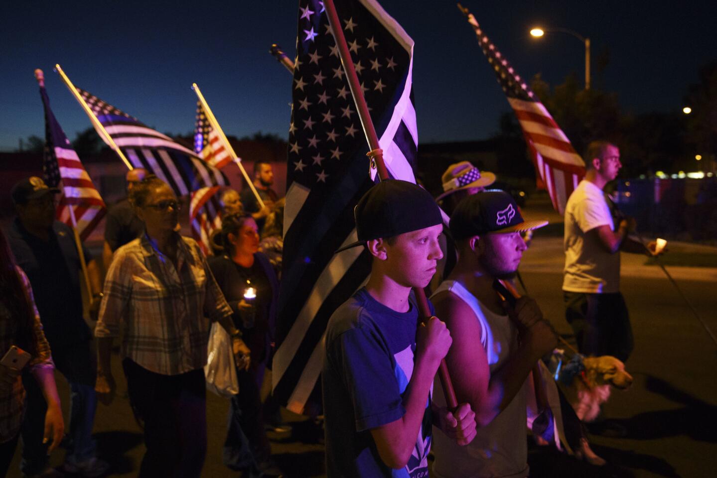 People mourn the death of Los Angeles County Sheriff's deputy Sgt. Steve Owen during a candlelight vigil in Lancaster on Saturday.