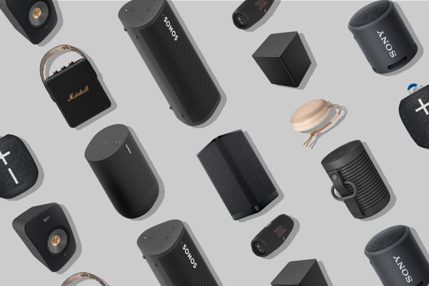 Array of various Bluetooth speakers against a gray background