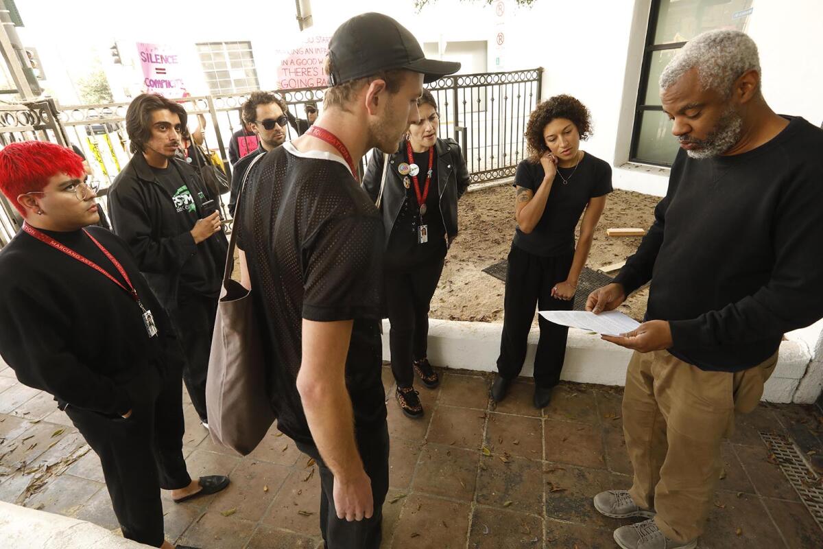 LAXart Director Hamza Walker receives a letter from former Marciano Art Foundation workers, who were laid off last week. The letter requests that the foundation's artistic director, Olivia Marciano, be removed from the LAXart board if she does not address the workers' questions.