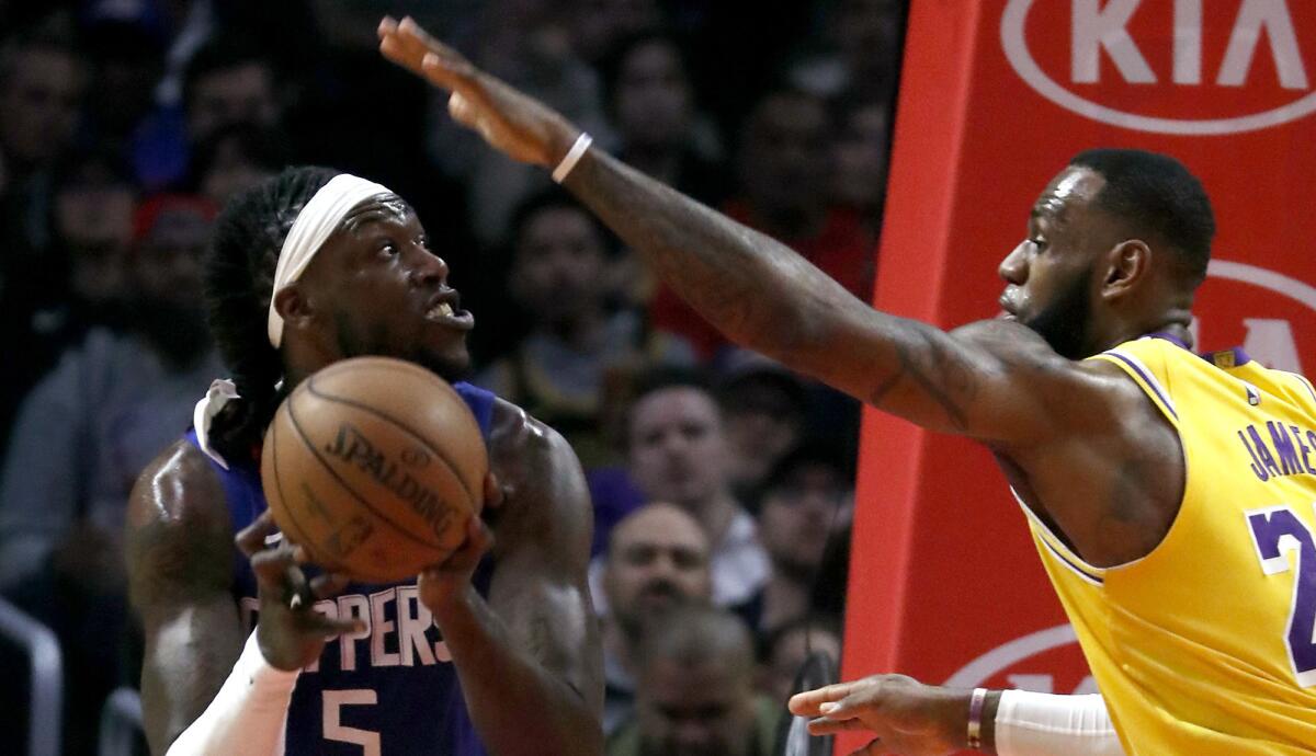 Clippers center Montrezl Harrell looks to score against Lakers forward LeBron James during a game last season.
