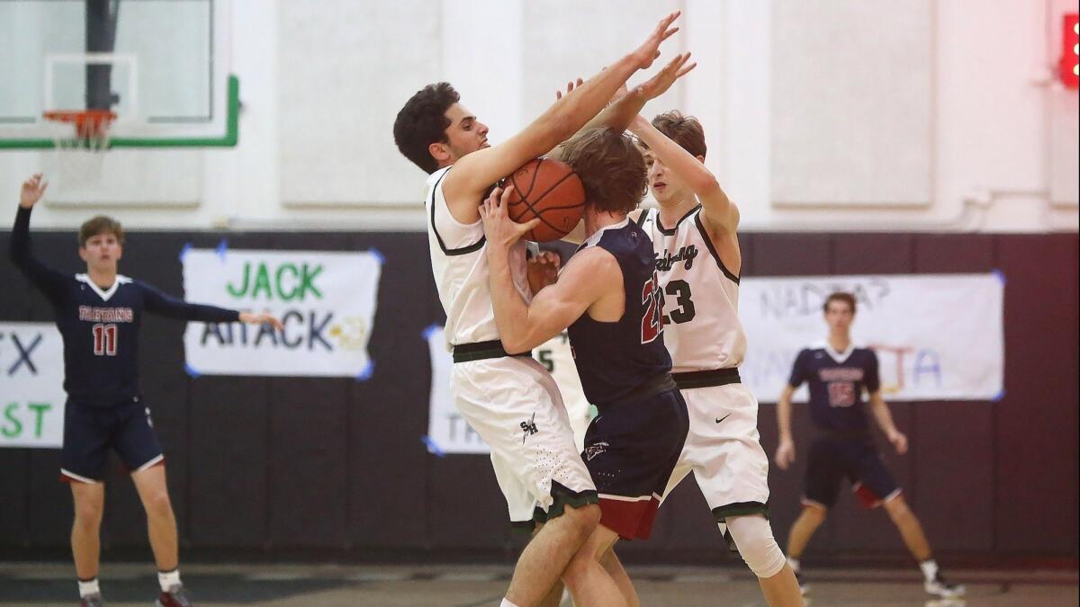 Sage Hill School defenders Darius ShayanSmith, left, and Jack Strohman, sandwich St. Margaret's Trey Pate, who turns the ball over in the Academy League championship game on Thursday.
