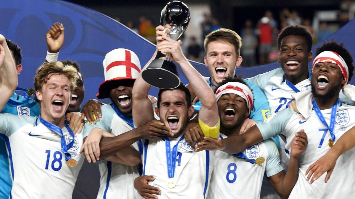 England's players celebrate with the trophy during the awards ceremony after winning the Under-20 World Cup on Sunday.