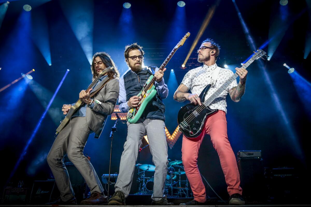 Brian Bell, Rivers Cuomo and Scott Shriner of Weezer perform at the Osheaga Music and Art Festival on Aug. 1, 2015, in Montreal.