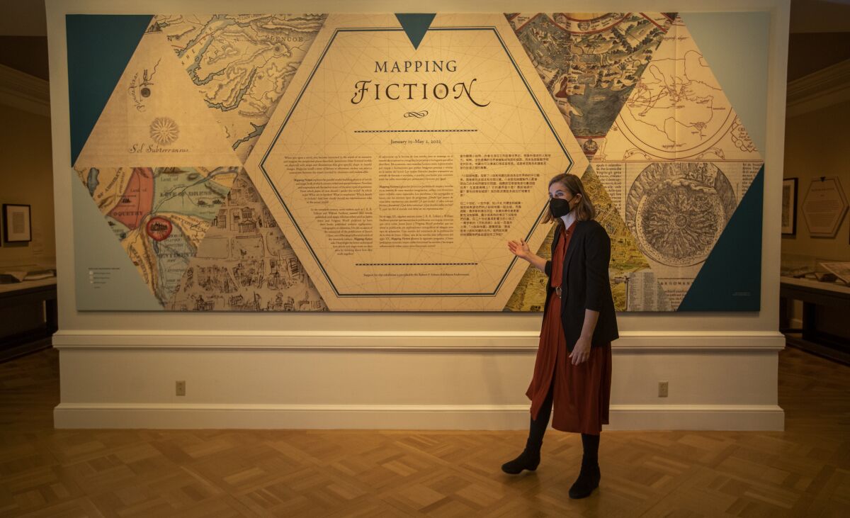 A woman in a mask stands in a museum.