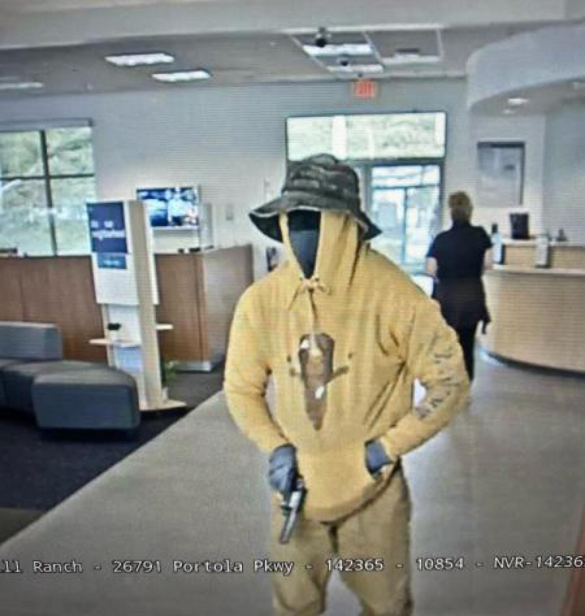 A male suspect armed with a handgun entered the bank and walked directly towards a bank teller.