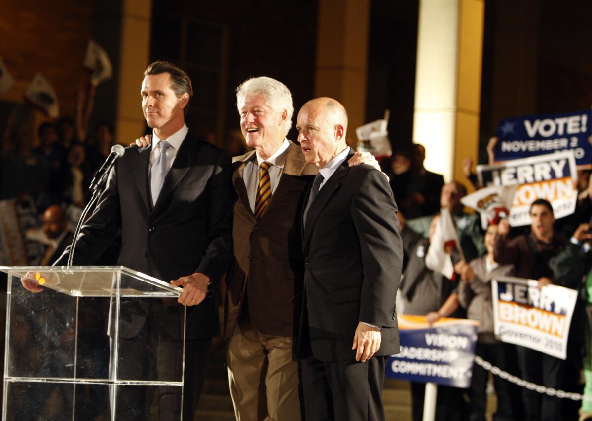 Gov. Jerry Brown, right, shares the stage with former President Bill Clinton, his nemesis in the 1992 race for the Democratic presidential nomination, and Lt. Gov. Gavin Newsom at a 2010 election rally.