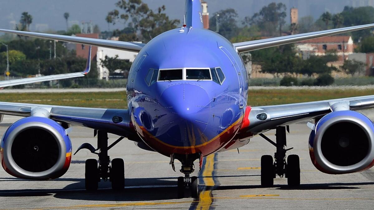 A Southwest Airlines jet taxis toward the terminal after arriving at Los Angeles International Airport in April 2011.