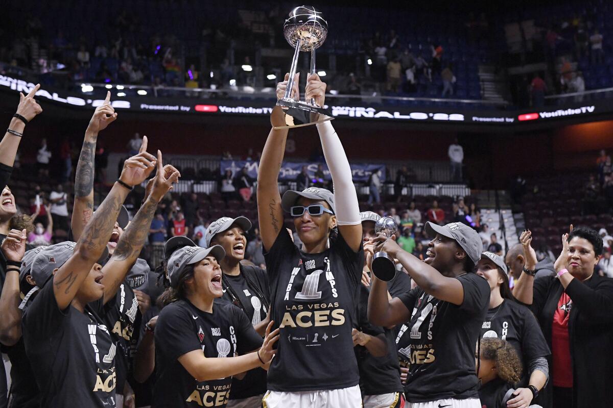 Las Vegas star A'ja Wilson holds up the WNBA championship trophy.