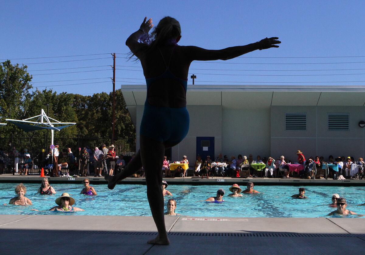 Deni King, an adult fitness instructor, leads a water aerobics routine at Verdugo Pool for the first ever "Rock-a-Hula" pool party for local seniors in Burbank on Thursday, August 21, 2014. Nearly 200 older adults came out to the event.