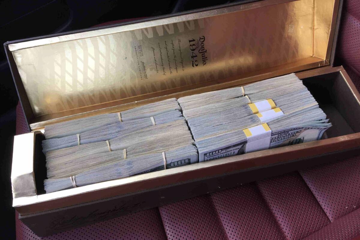Bundles of cash in a liquor box.