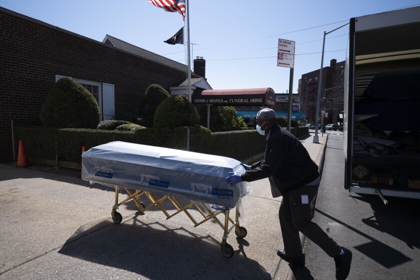 A man pushes a casket.