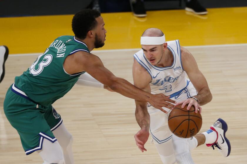 Los Angeles Lakers' Alex Caruso (4) drives against Dallas Mavericks' Willie Cauley-Stein (33) during the first half of an NBA basketball game Friday, Dec. 25, 2020, in Los Angeles. (AP Photo/Ringo H.W. Chiu)