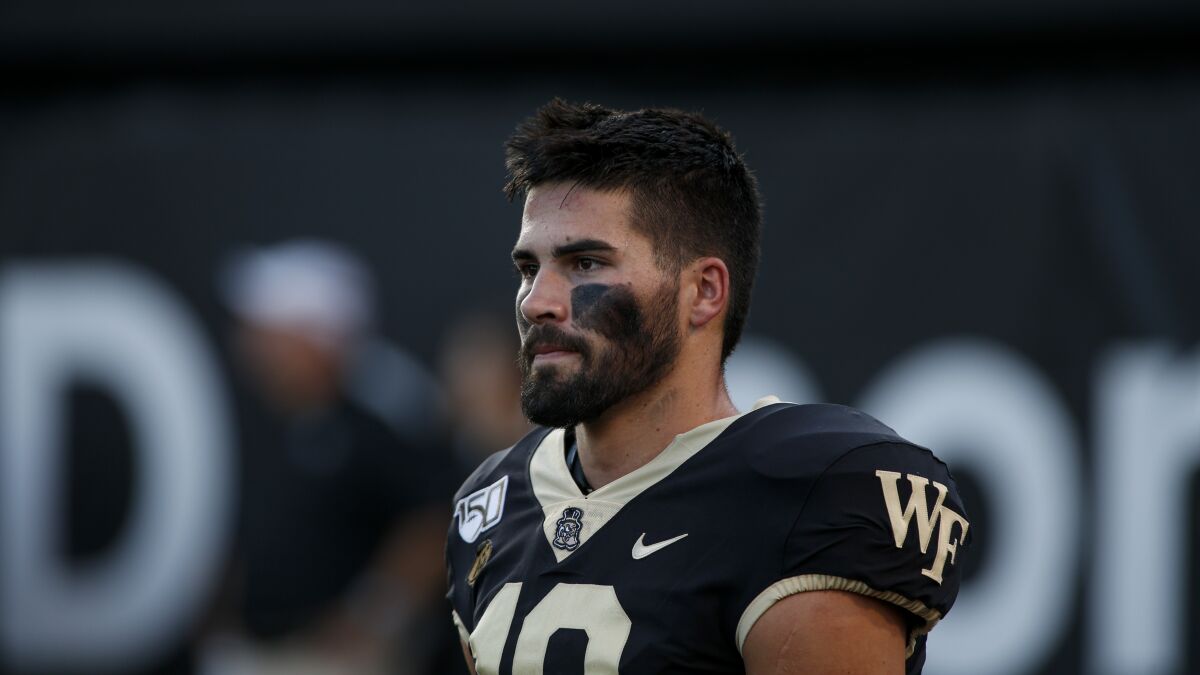 Wake Forest quarterback Sam Hartman stands on the field before an NCAA college football game against Utah State in Winston-Salem, N.C., Aug. 30, 2019. Hartman and the Demon Deacons host Old Dominion in Friday's season opener. (AP Photo/Nell Redmond)